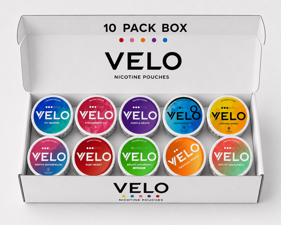 An open white VELO nicotine pouches box showing a 10-pack of colorful single-serve pouches arranged in two rows. The top of the box reads '10 PACK BOX VELO NICOTINE POUCHES,' and the pouches display different flavor labels including Citrus Zing, Purple Grape, Tobacco Shop, White Watermelon, Berry Blast, and Arctic Grapefruit.