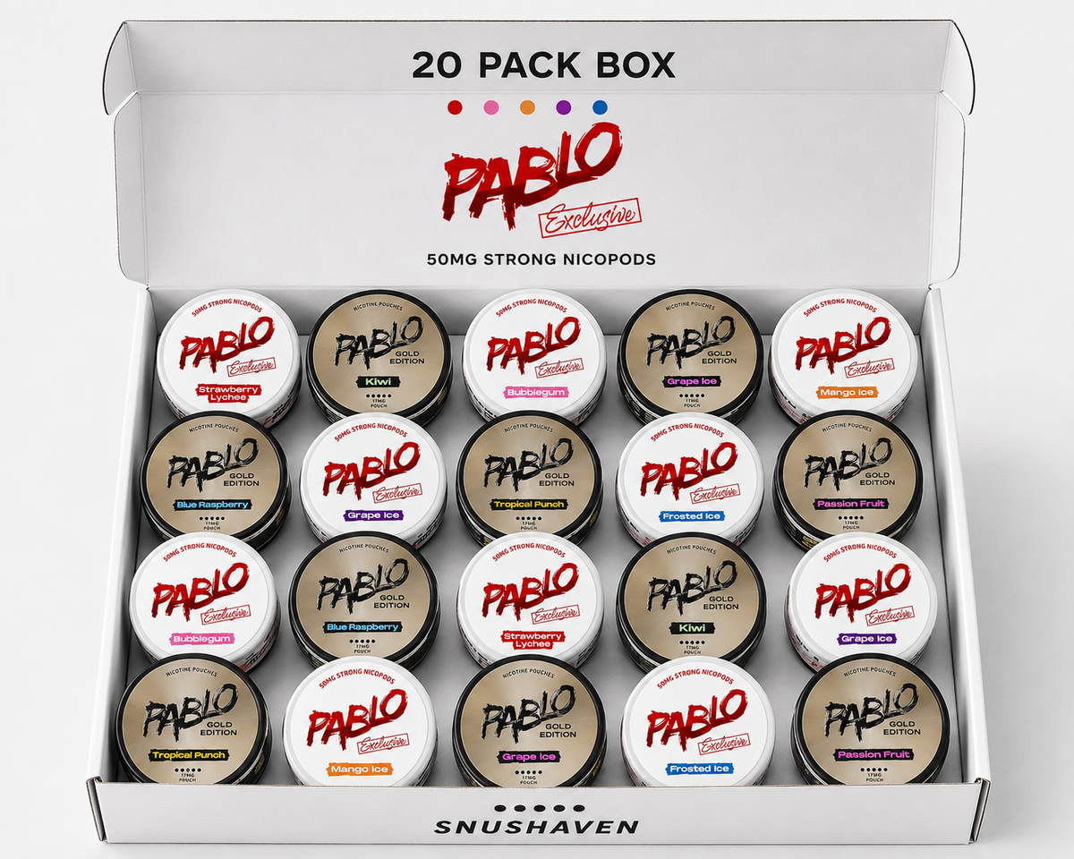 An open white Pablo Exclusivo 20-pack box containing 20 small round nicotine pods with various colored labels, displayed on a clean white background.